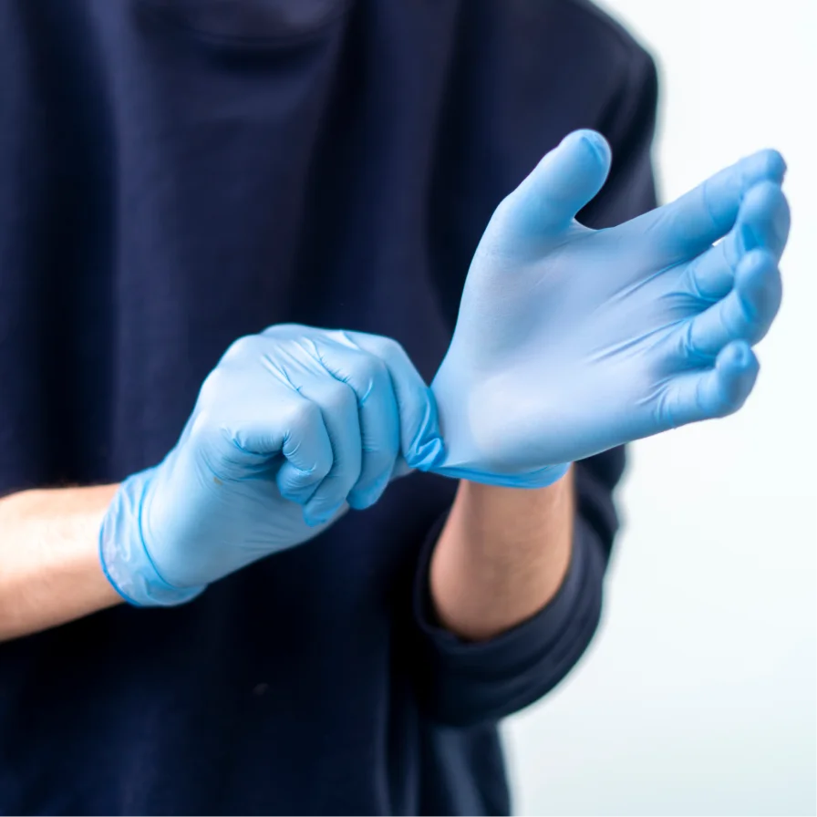 Person wearing light blue disposable nitrile gloves wholesale for protection and hygiene
