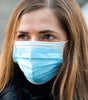 Woman wearing a blue medical-grade face mask wholesale for effective protection and safety