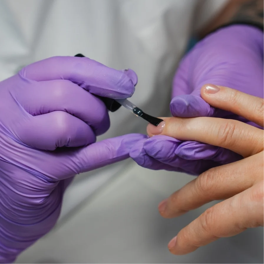 Purple nitrile gloves by CE Disposables used during a manicure for hygienic protection
