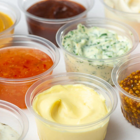 Variety of sauces in clear disposable portion cups condiment cup for serving sauces and dips
