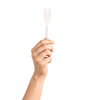 Hand holding a white CE Disposables fork, perfect for parties and outdoor events